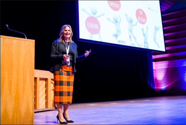 Woman on stage speaking